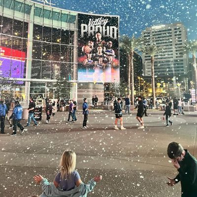 People enjoying artificial snow in Washington DC, playing and having fun in a winter wonderland atmosphere created by fluffy white snow covering the ground